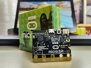 BBC Micro Bit with its original packaging behind it.
