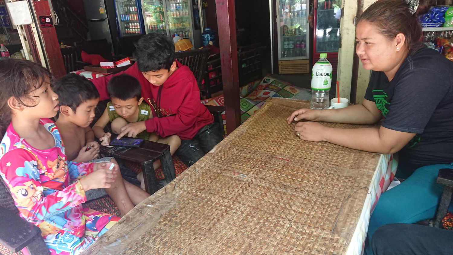 Kids playing a game app on smartphone. They play games everyday, said the mother. Wat Bo, Siem Reap